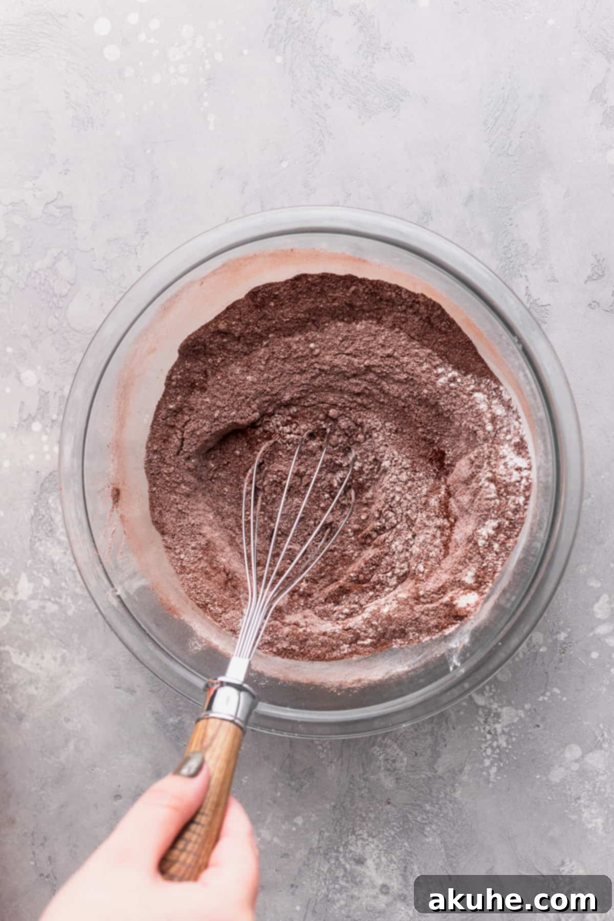 Dry ingredients in a glass bowl, ready for mixing.