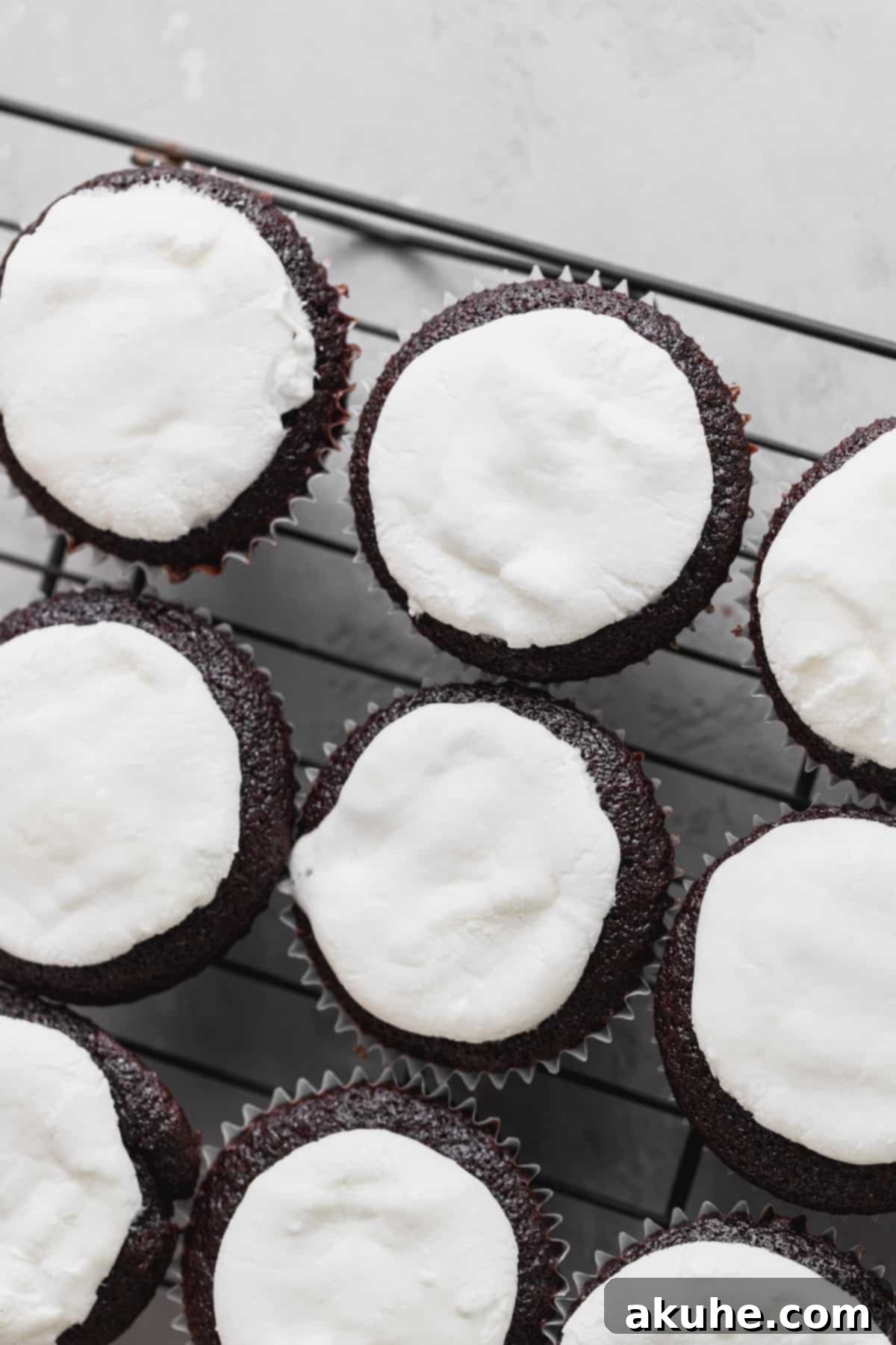 Marshmallows placed on top of warm cupcakes.