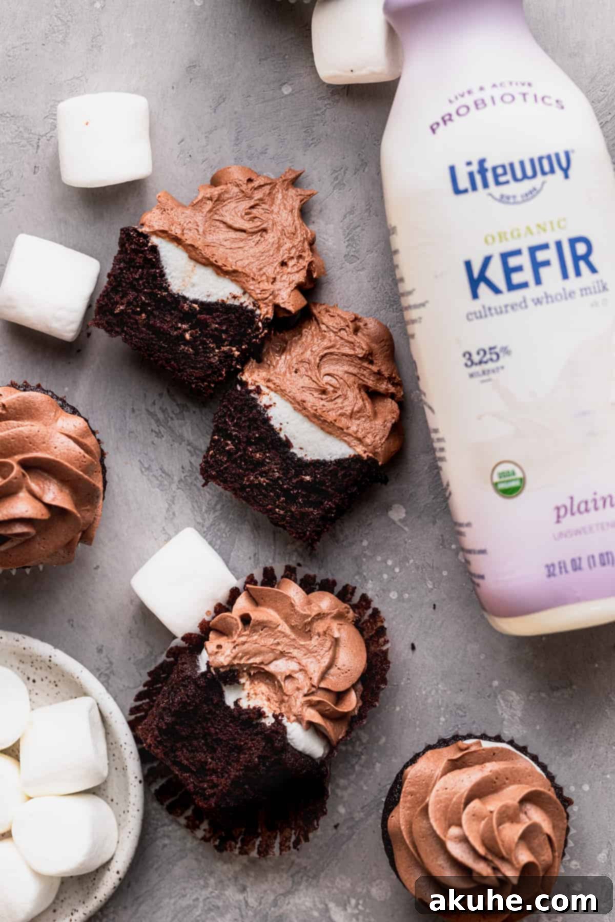 A hot chocolate cupcake split open, showcasing its moist texture and marshmallow center.