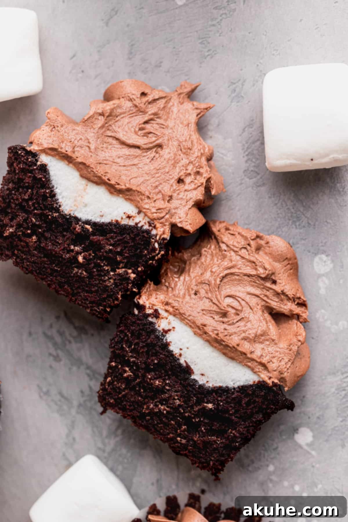 Hot chocolate cupcakes split in half, showing their inner texture and marshmallow.