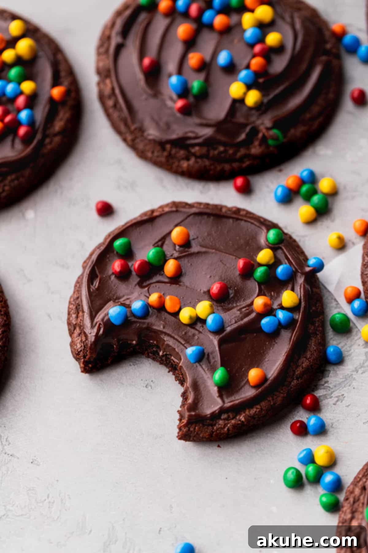 Deep Space Fudge Cookies 11 A close-up shot of a Cosmic Brownie Cookie with a bite taken out, revealing its fudgy, rich chocolate interior and chewy texture.