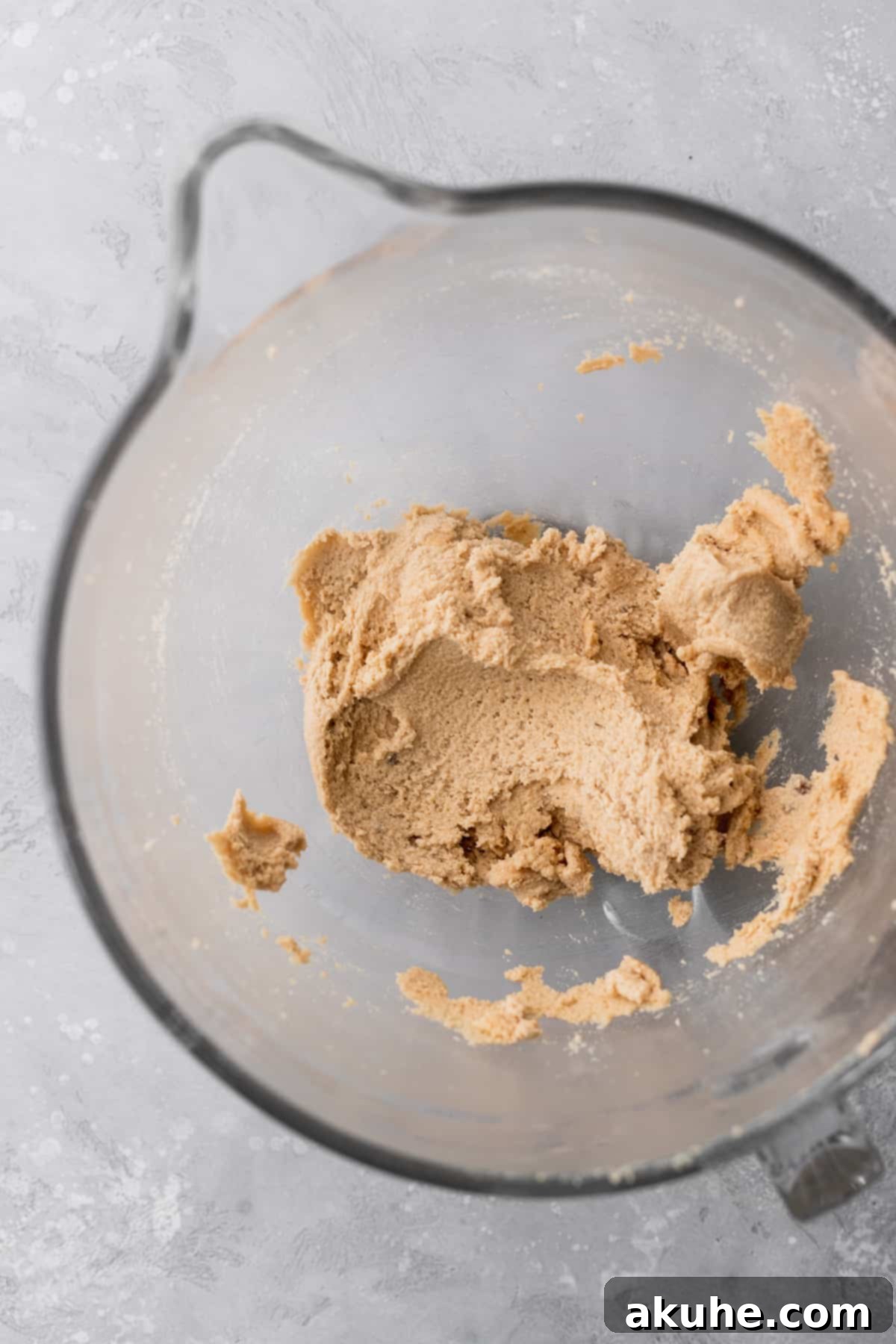 Deep Space Fudge Cookies 4 Close-up of fluffy, creamed butter and sugar in a clear glass mixing bowl, showing the light texture achieved before adding chocolate.