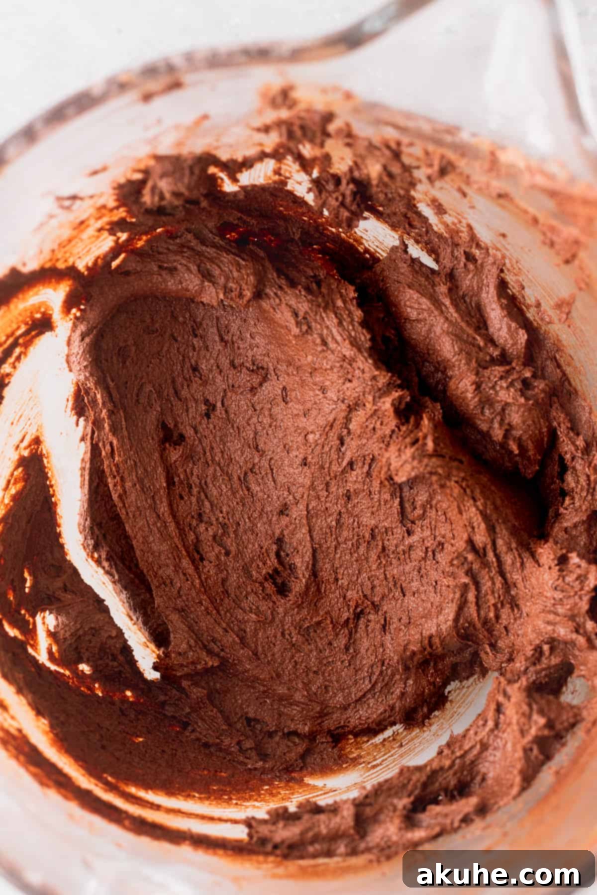 Deep Space Fudge Cookies 7 Smooth, rich chocolate cookie dough resting in a glass bowl after mixing, ready for chilling and scooping.