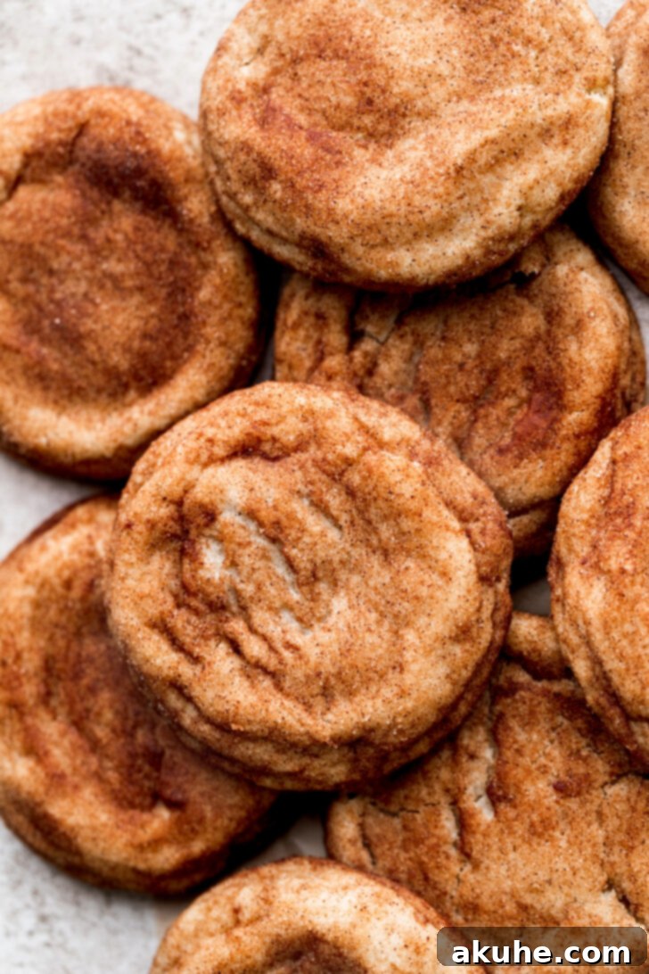 A generous pile of freshly baked brown butter snickerdoodles, highlighting their golden-brown edges and crinkly tops.