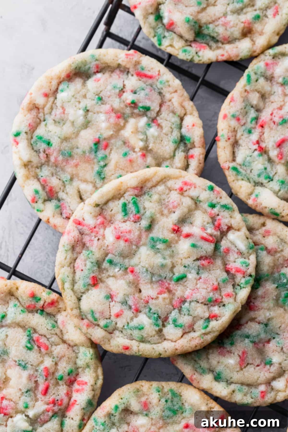 Merry & Bright Sprinkle Cookies 7 Freshly baked Christmas sprinkle cookies cooling on a wire rack.
