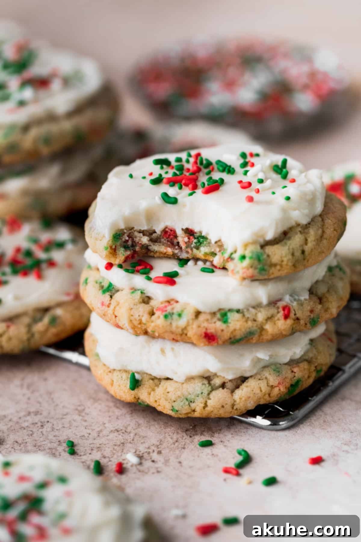 Merry & Bright Sprinkle Cookies 8 A stack of three beautifully frosted Christmas sprinkle cookies, ready to be enjoyed.
