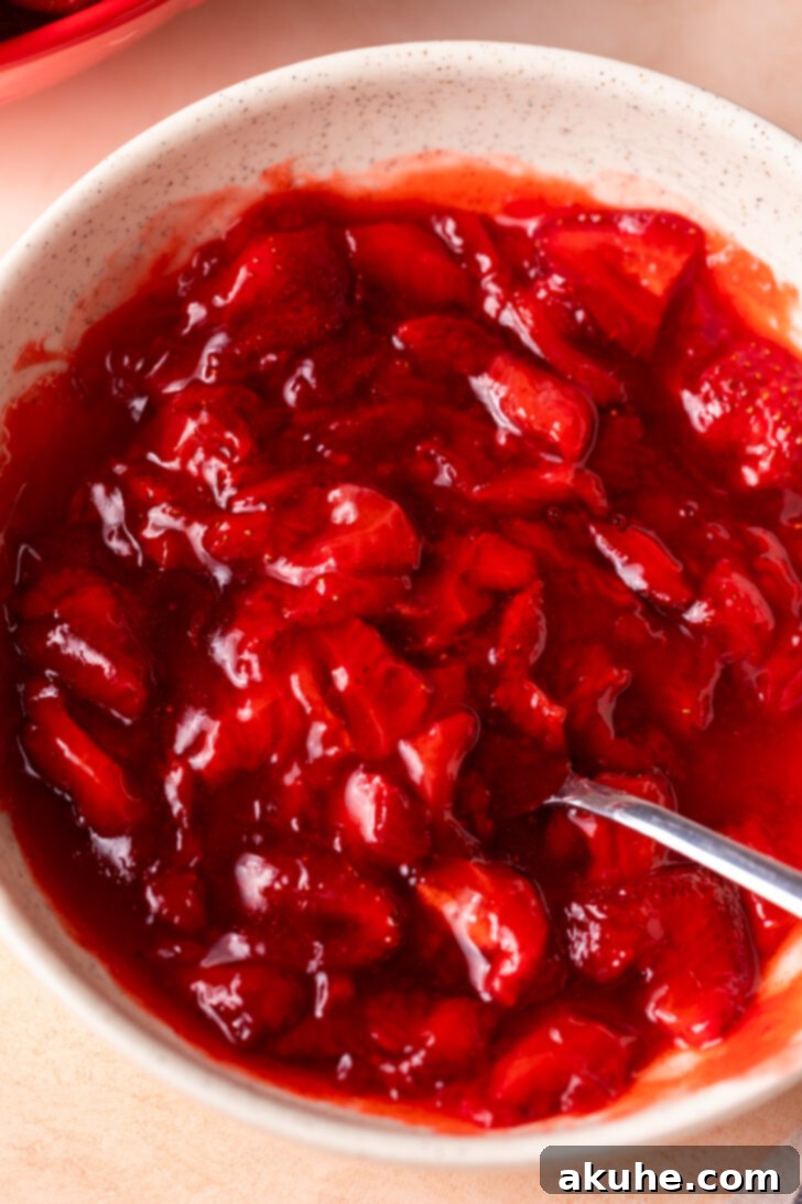Strawberry Cheesecake Squares 7 Vibrant strawberry sauce in a bowl, cooling down.