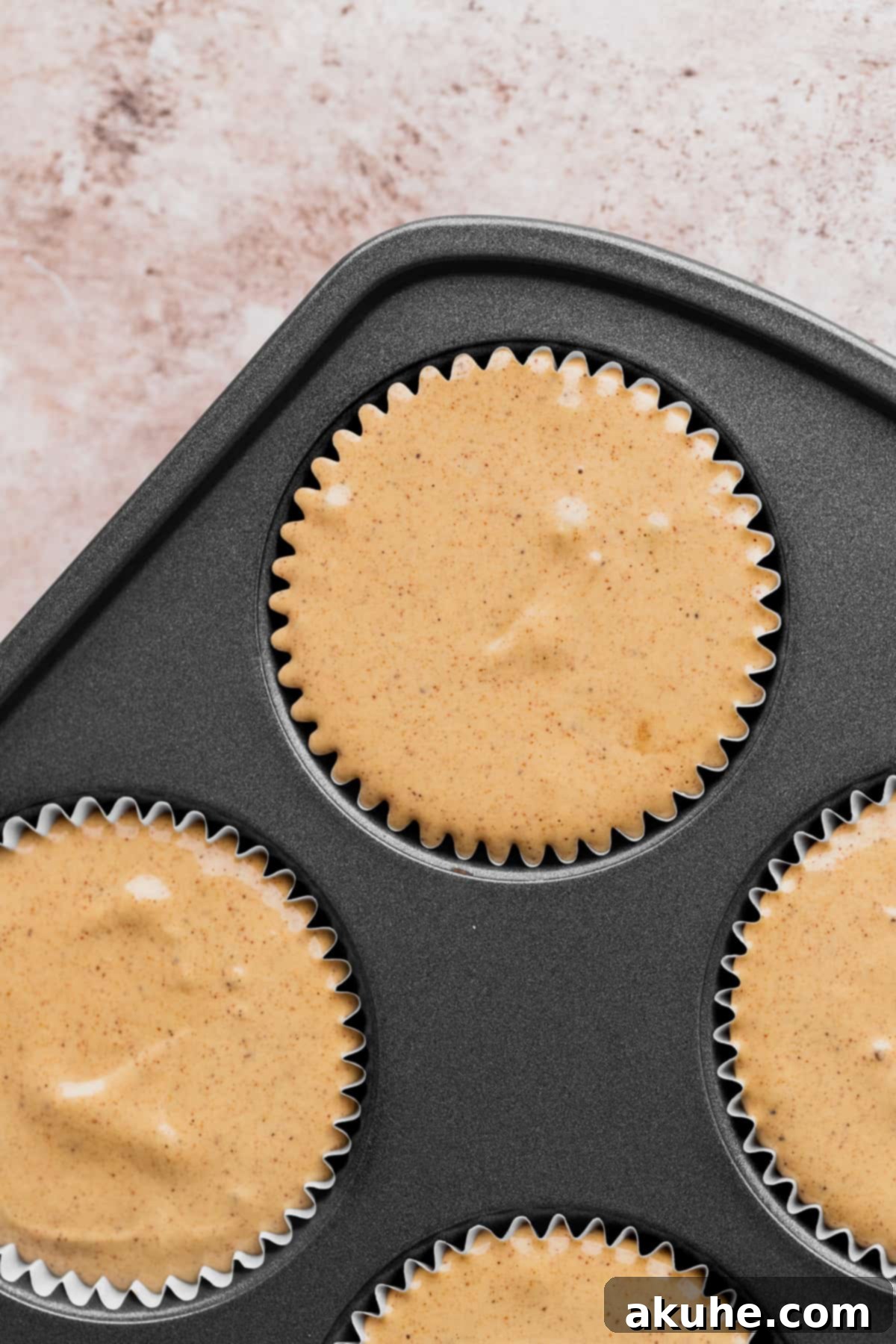 Holiday Gingerbread Cheesecake Delights 7 Cheesecake batter in a muffin pan.