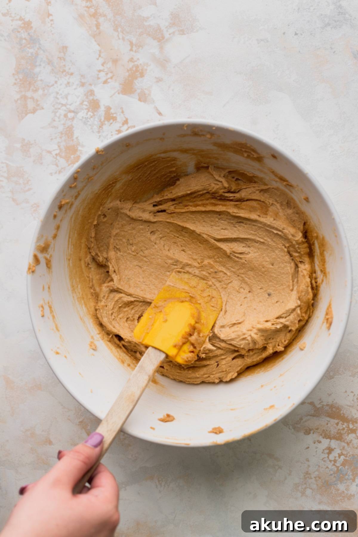 Wet ingredients including eggs and vanilla extract being combined in a bowl, creating a light and fluffy mixture.