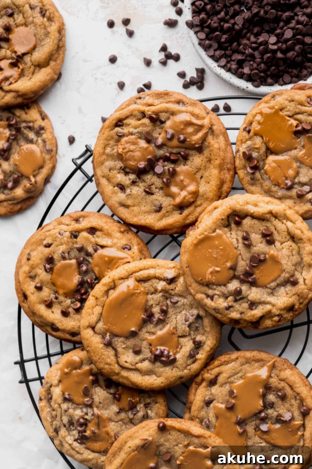 A baking tray laden with warm, freshly baked Biscoff butter cookies, each topped with melted cookie butter.