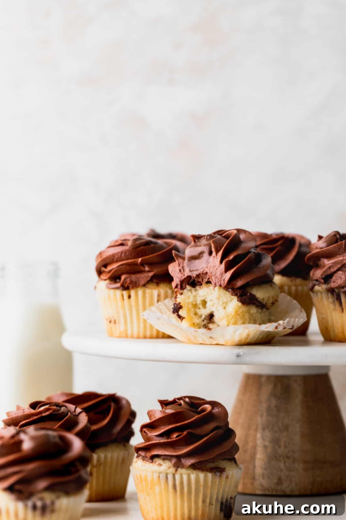 Irresistible Vanilla Nutella Cupcakes 11 Beautifully frosted vanilla Nutella cupcakes presented together on a delicate cake stand, a perfect dessert spread.