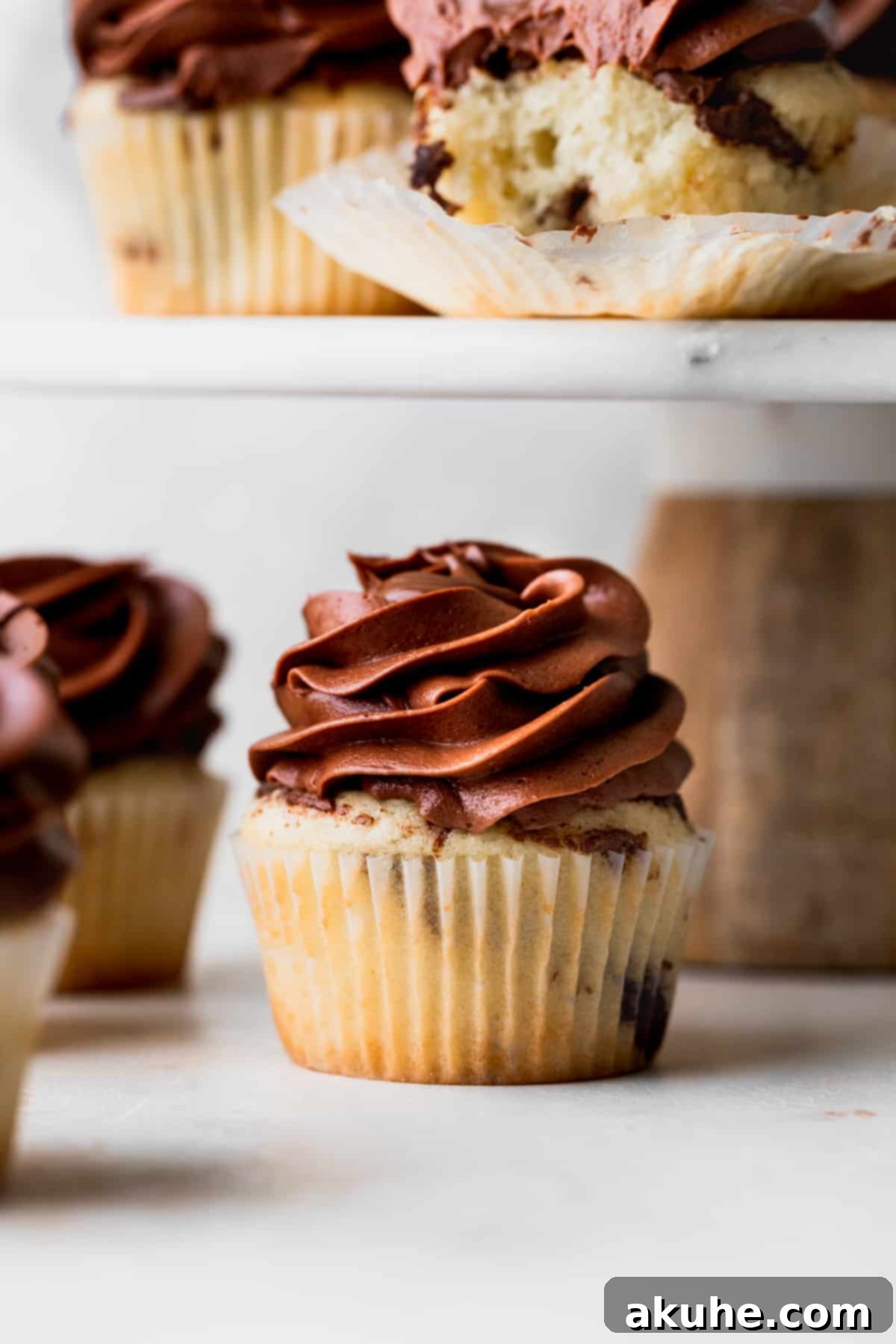 Irresistible Vanilla Nutella Cupcakes 12 A single, perfectly frosted Nutella cupcake, showcasing its rich topping and moist cake, ready to be enjoyed.