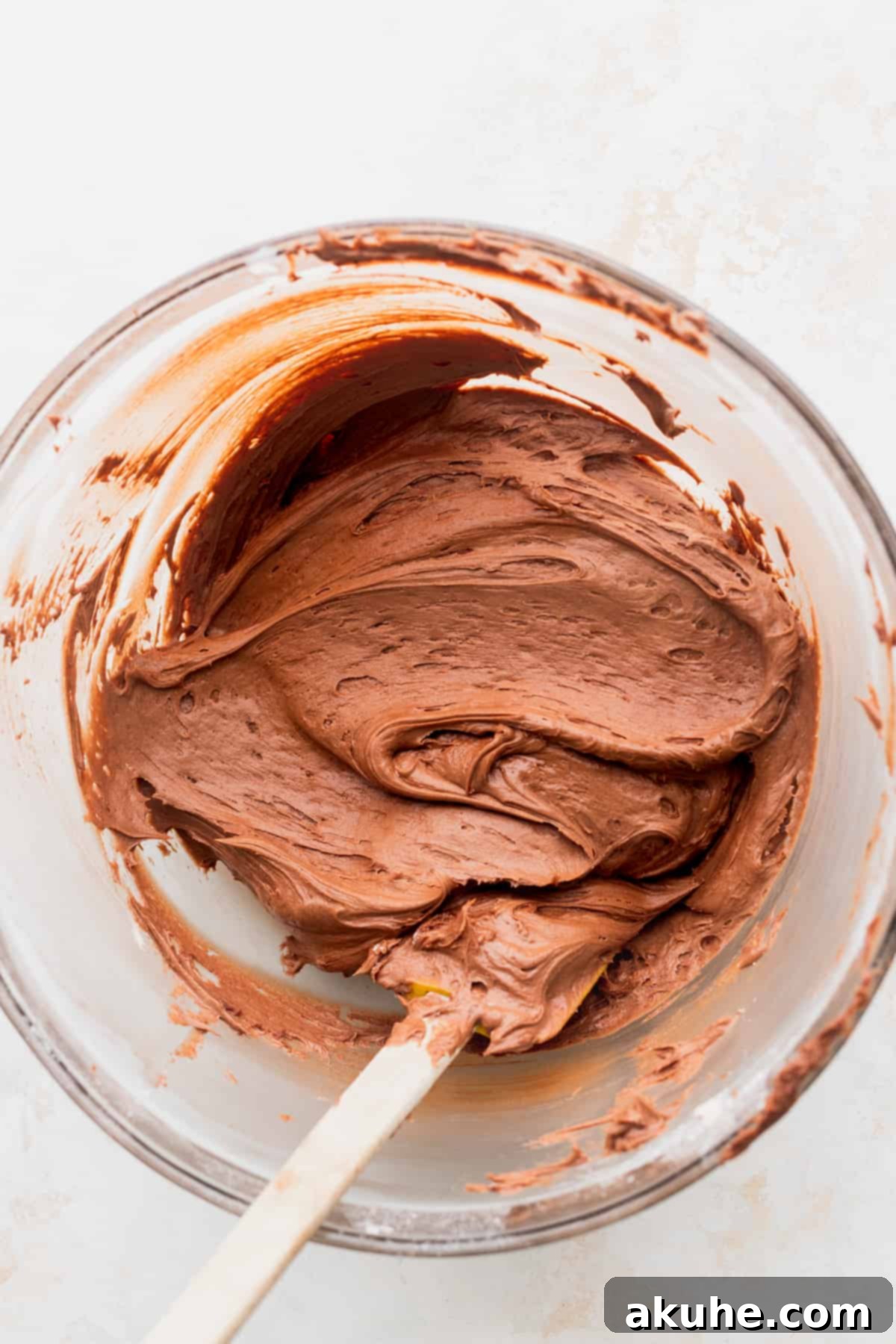 Irresistible Vanilla Nutella Cupcakes 8 Rich, fluffy chocolate Nutella frosting in a glass bowl, perfectly whipped and ready for decorating the cupcakes.