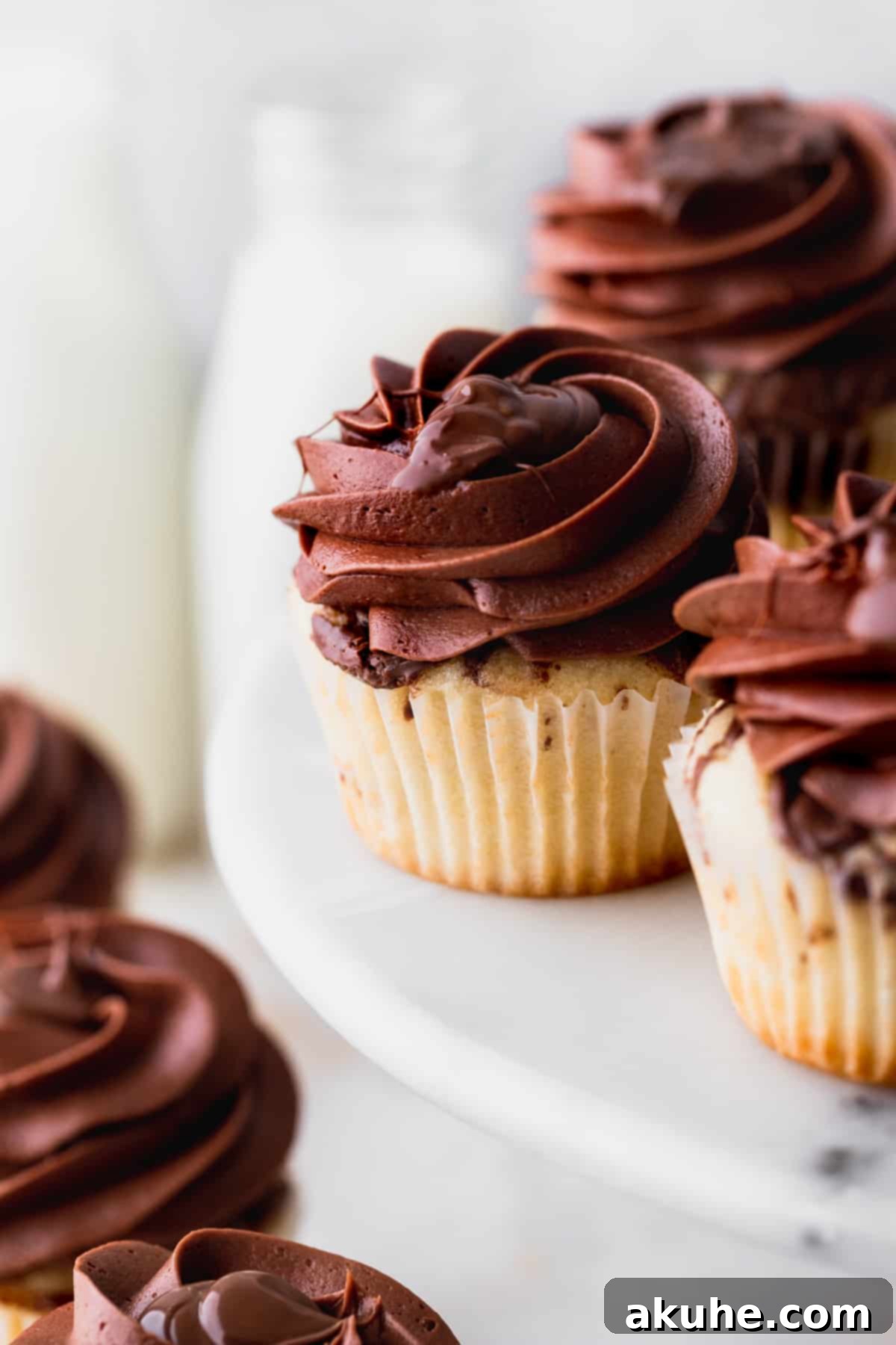 Irresistible Vanilla Nutella Cupcakes 10 A close-up view of a single, perfectly decorated vanilla Nutella cupcake with generous frosting and a tempting swirl of Nutella on top.