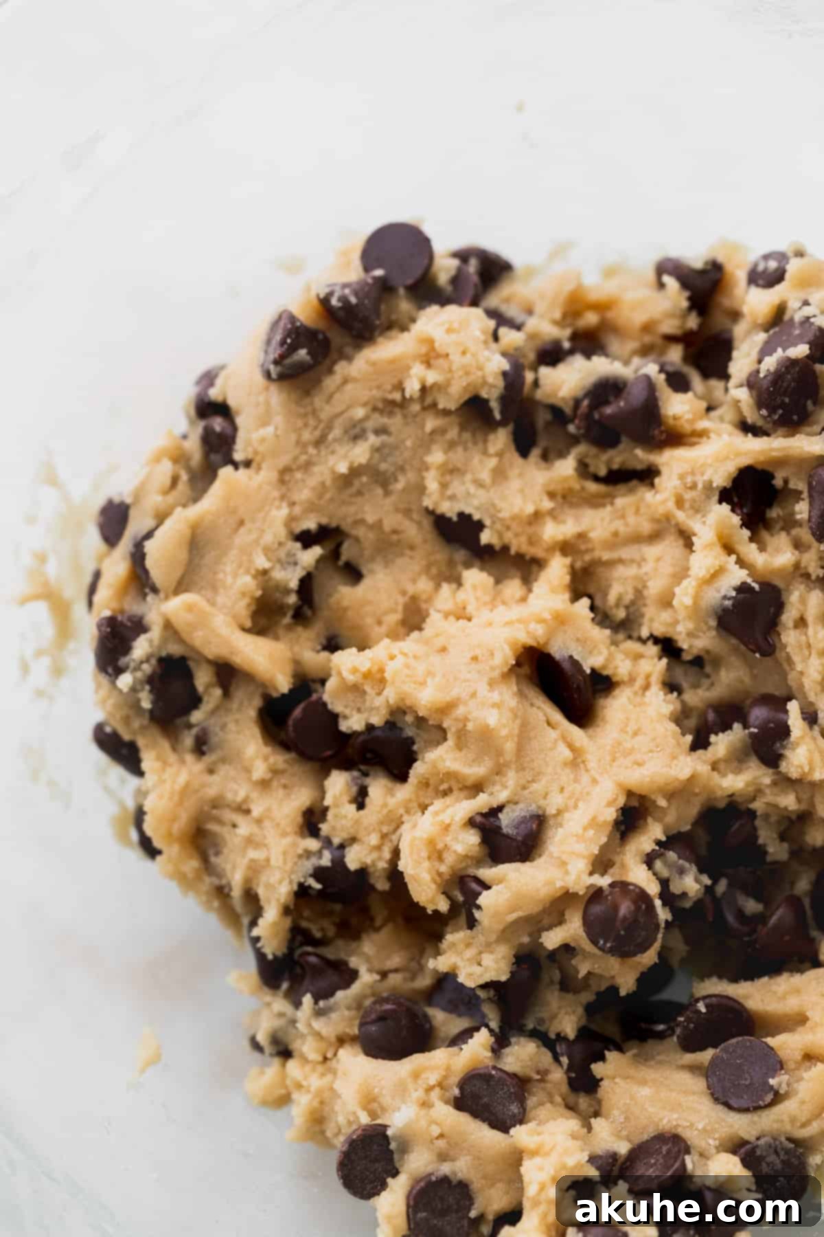 Just Enough Chocolate Chip Bliss 6 Chocolate chip cookie dough in a clear glass bowl, ready for scooping.