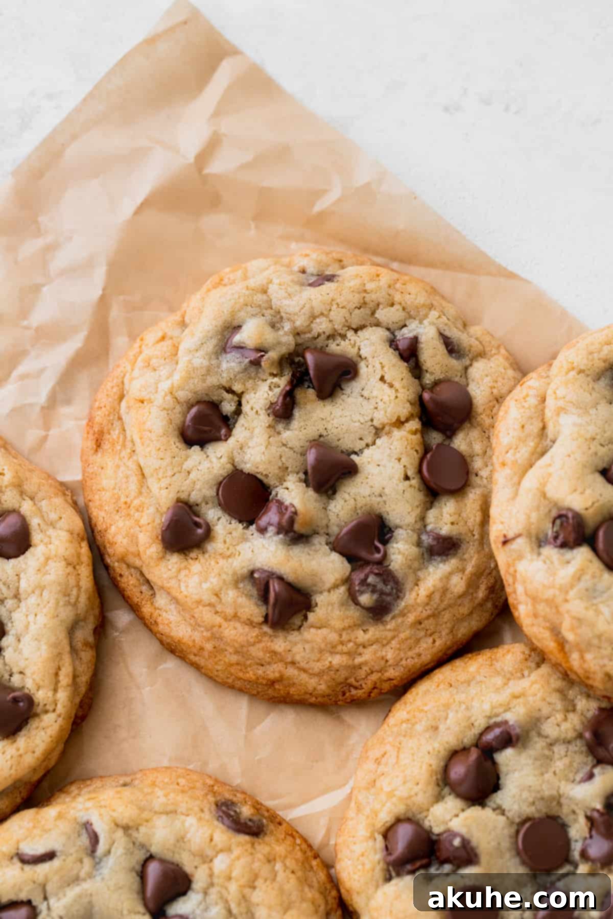 Just Enough Chocolate Chip Bliss 10 Close up image of several small batch chocolate chip cookies, stacked and scattered, highlighting their texture.