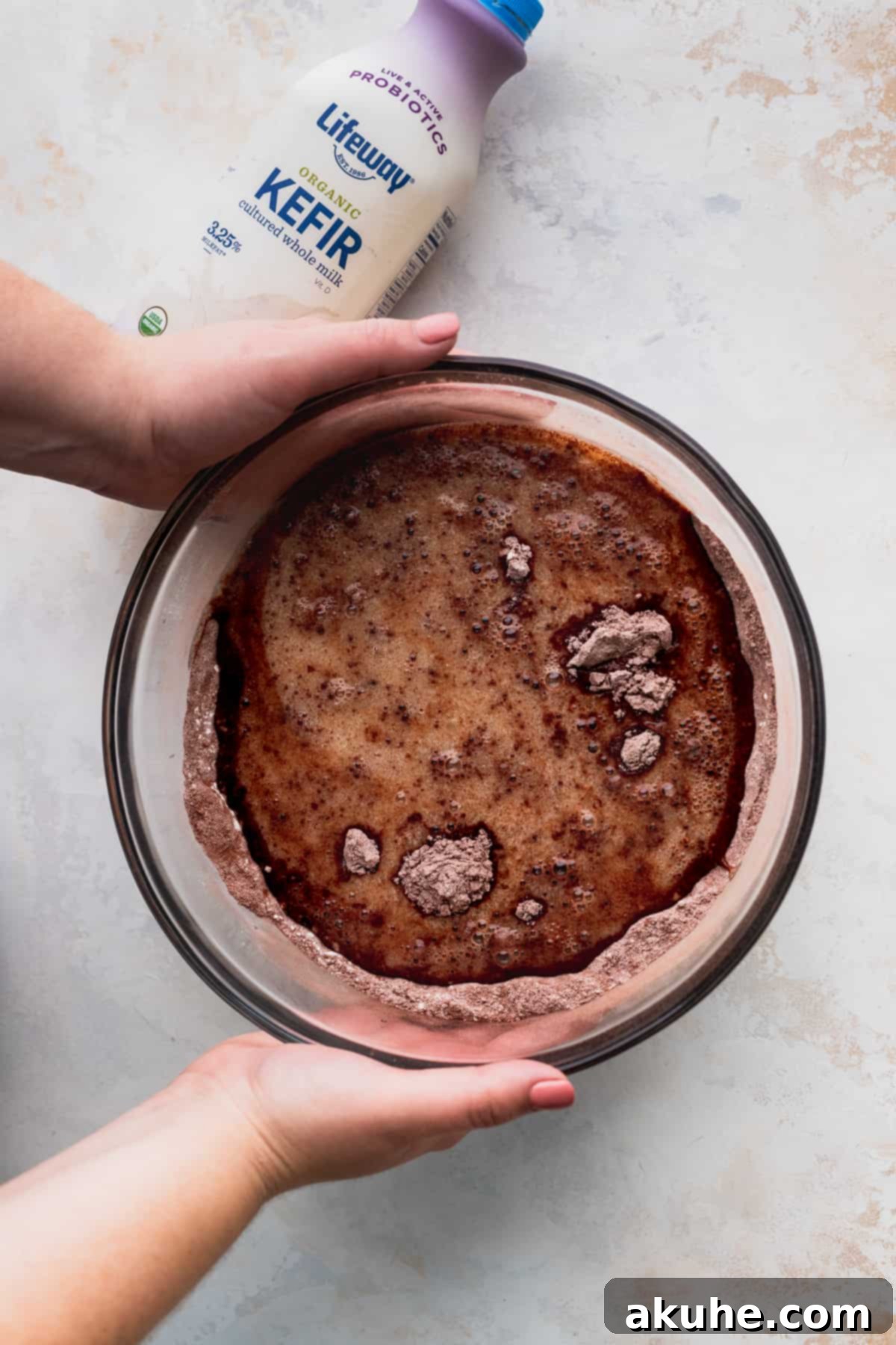Blueberry Chocolate Layer Cake 4 Wet ingredients being slowly poured into dry ingredients for the chocolate cake batter, ensuring smooth incorporation.