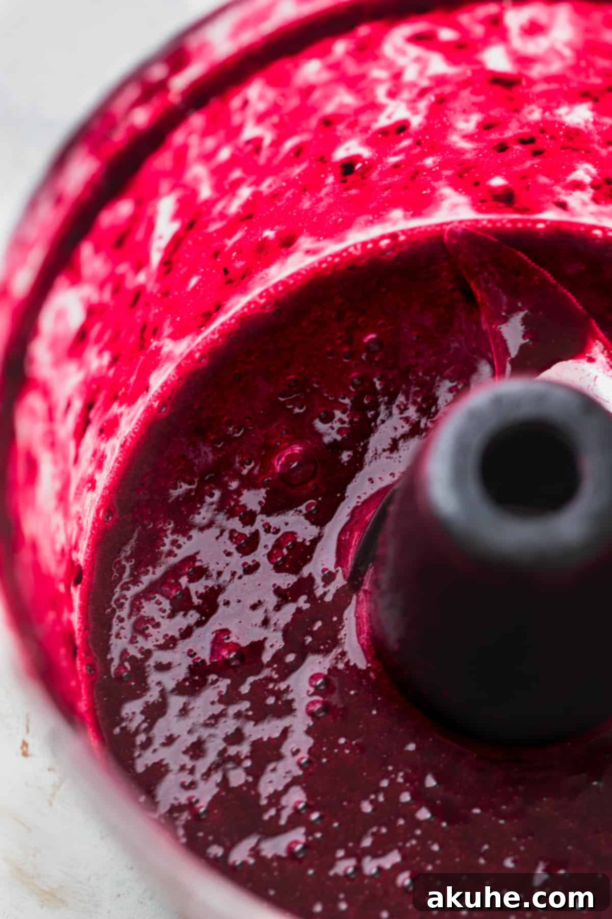 Blueberry Chocolate Layer Cake 7 Smooth, rich blueberry puree being prepared in a blender, capturing the essence of fresh blueberries for the frosting.