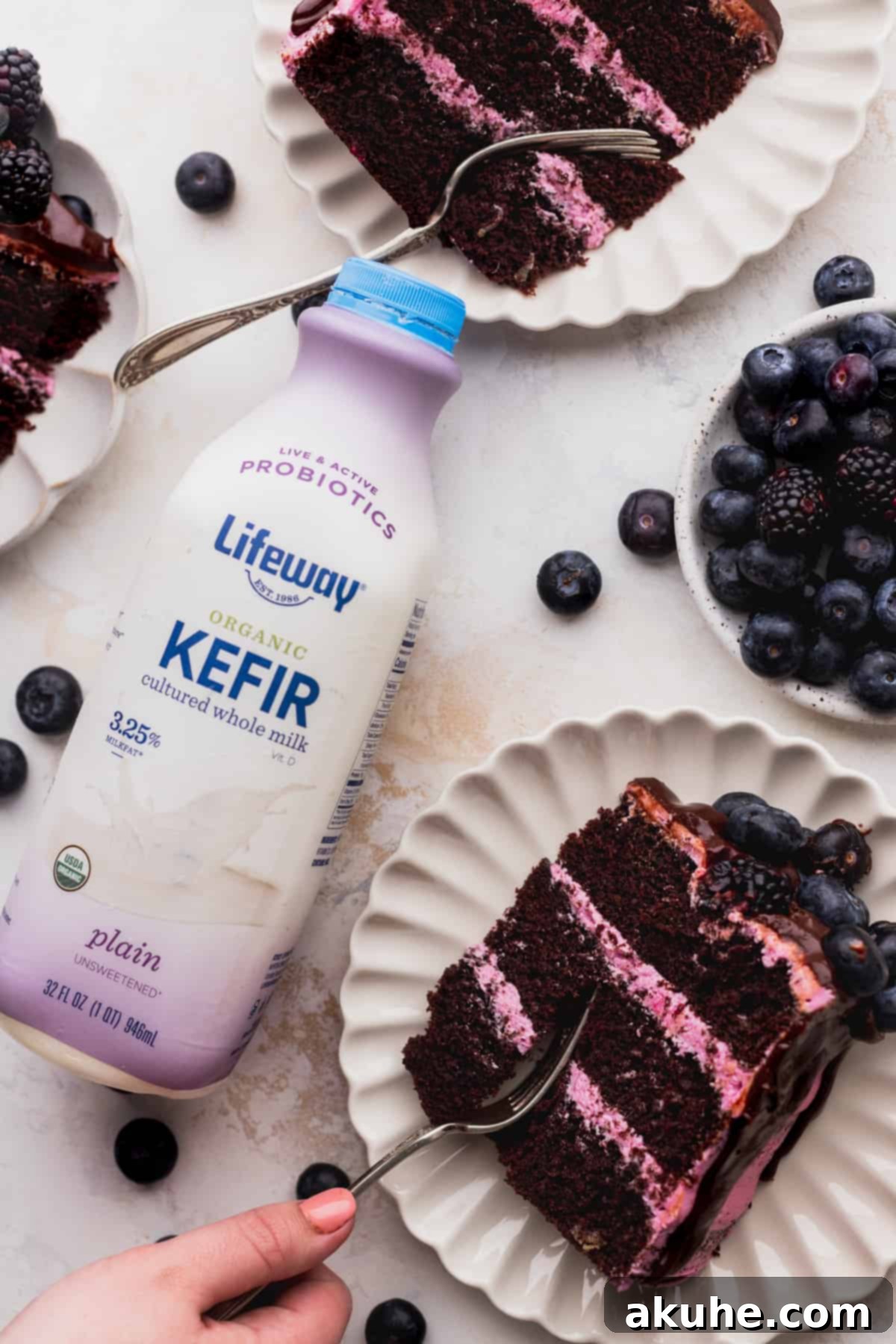 Blueberry Chocolate Layer Cake 9 Individual slices of the decadent layered blueberry chocolate cake served on white plates, each with a fork ready to enjoy.