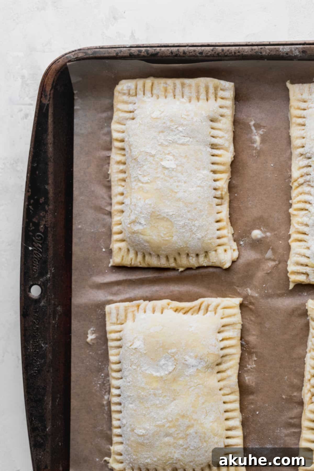 Ultimate Chocolate Cookie Dough Pop Tarts 9 Unbaked puff pastry pop tarts on a baking sheet before chilling.