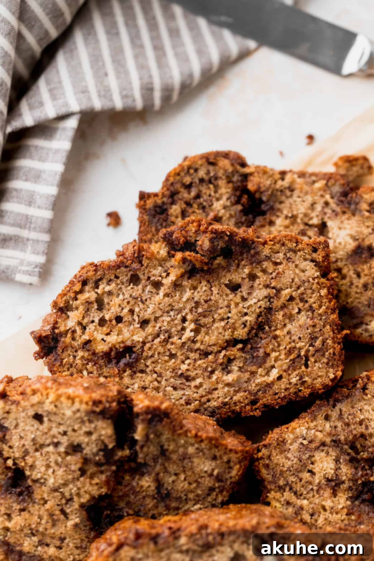 Irresistible Cinnamon Swirl Banana Bread 12 Piles of banana bread on parchment paper.