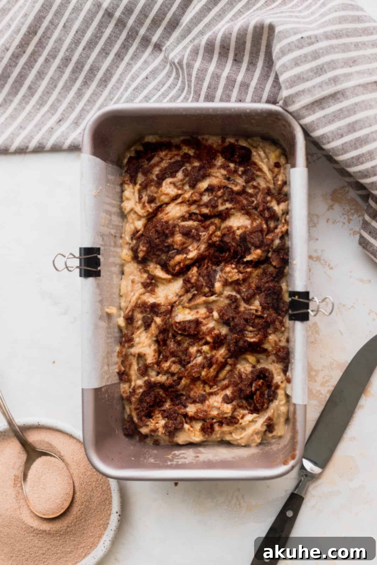 Irresistible Cinnamon Swirl Banana Bread 6 Half of batter in the loaf pan with cinnamon swirl.