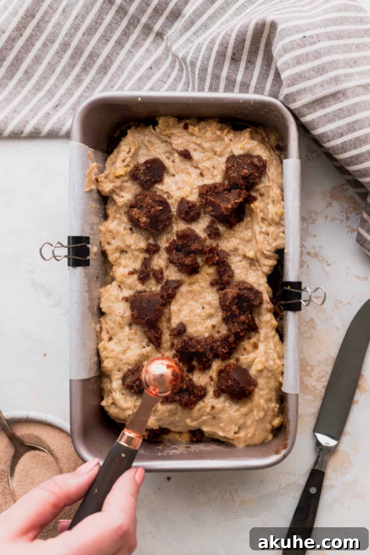 Irresistible Cinnamon Swirl Banana Bread 7 Scooped cinnamon filling on top of batter.