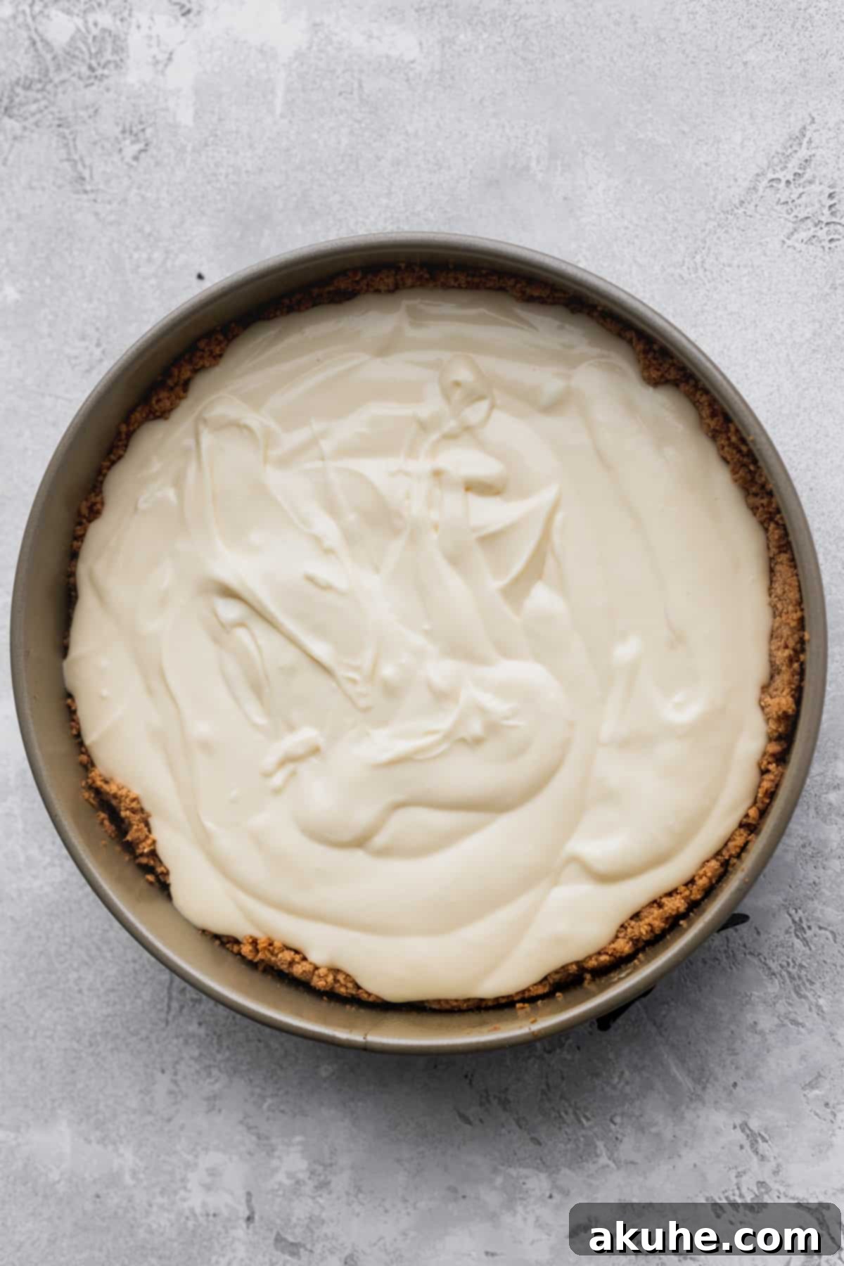 Decadent White Chocolate Cheesecake 7 Smooth cheesecake batter poured into a prepared springform pan, ready for the oven.