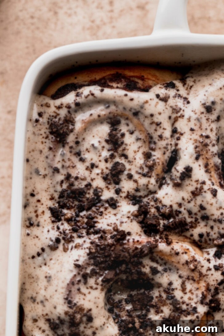 A top-down view of a pan of freshly glazed Oreo cinnamon rolls, glistening and inviting.