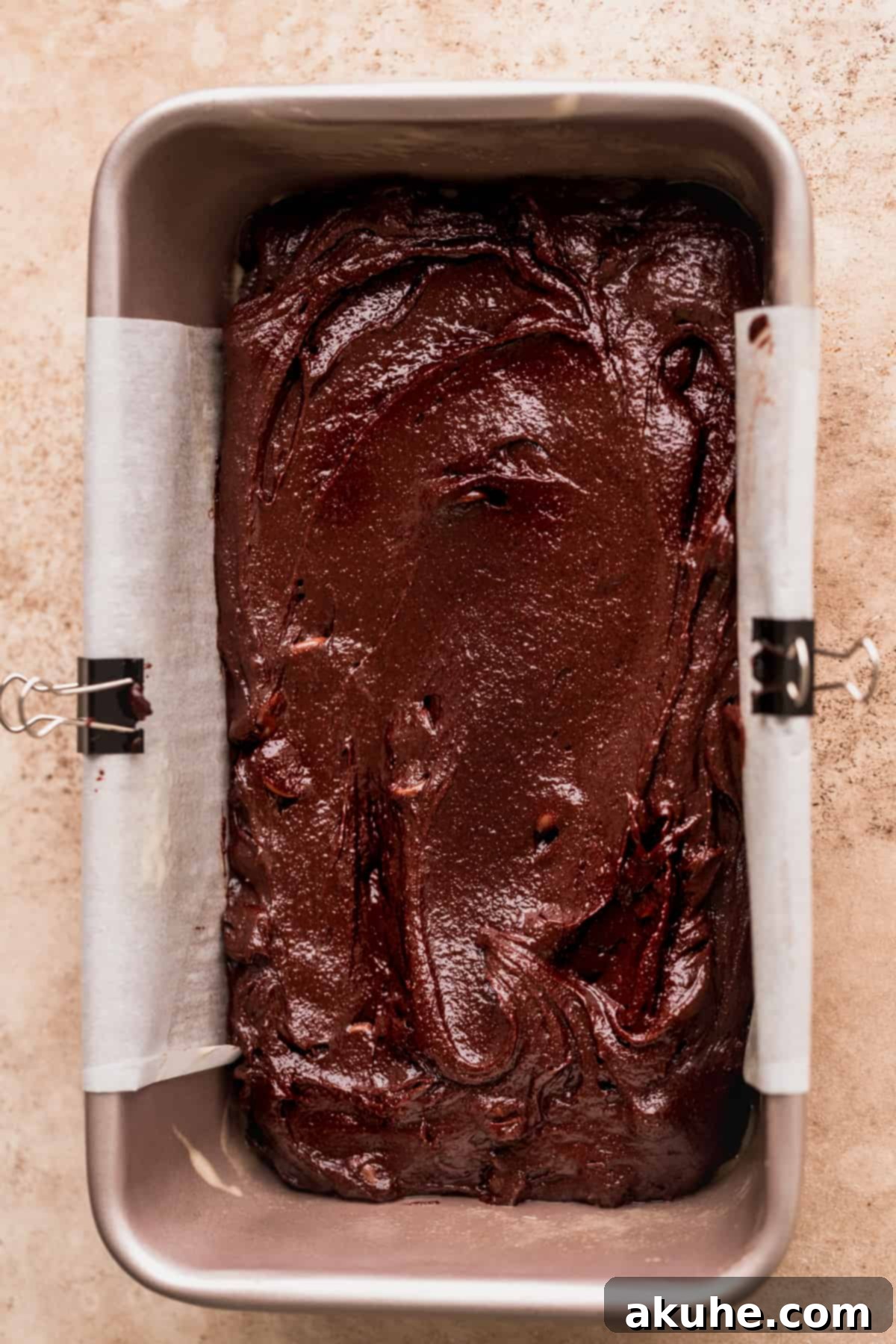 Artisan Brownie Bites 7 Brownie batter spread evenly in a loaf pan, ready for baking.