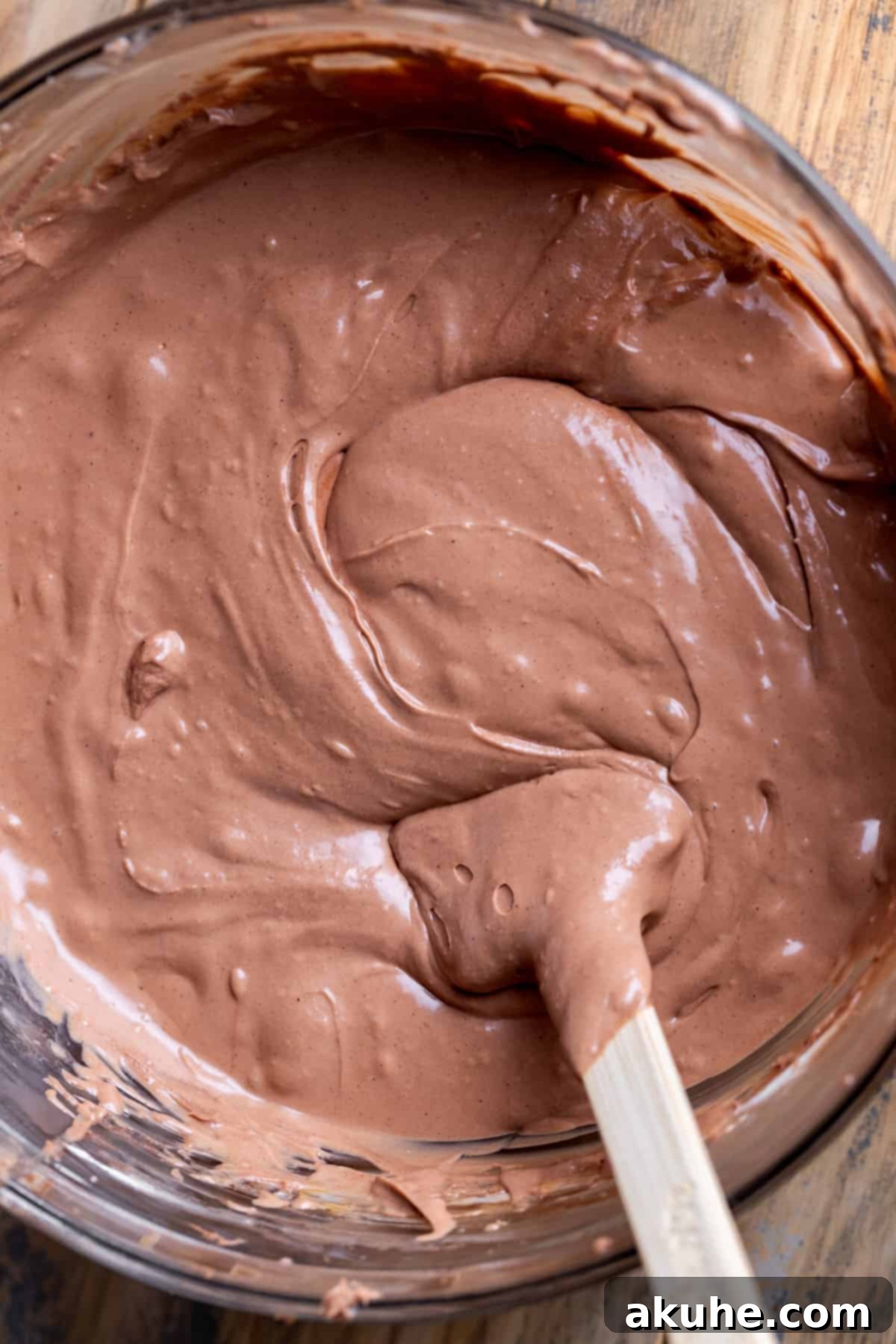 Decadent Nutella Cheesecake 5 Smooth, rich Nutella cheesecake batter in a glass mixing bowl, ready for baking.