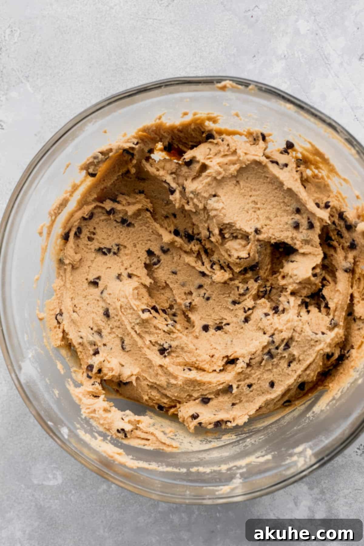 Decadent Peanut Butter Nutella Cookies 5 Rich cookie dough in a glass bowl, showcasing its soft texture before chilling.