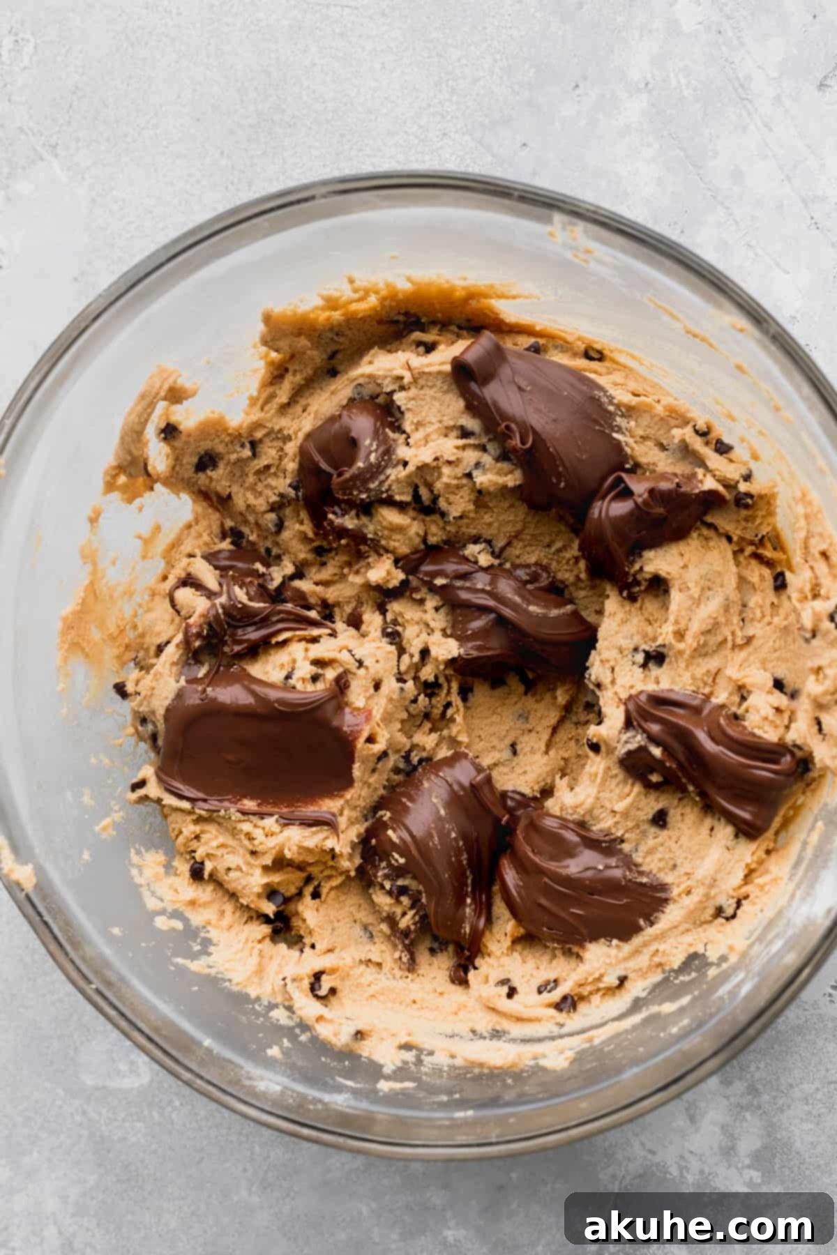 Decadent Peanut Butter Nutella Cookies 6 Dollops of Nutella scattered on top of cookie dough, ready for swirling.