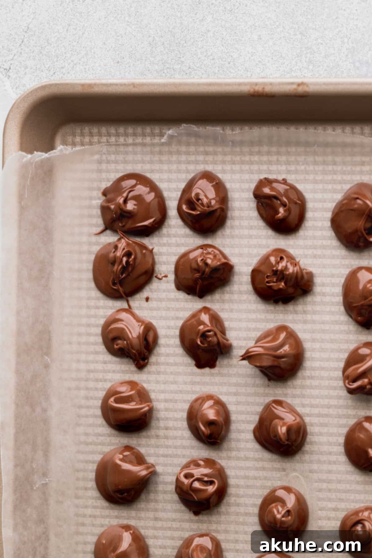 Decadent Peanut Butter Nutella Cookies 8 Frozen drops of Nutella arranged on a parchment-lined cookie sheet, ready to top warm cookies.