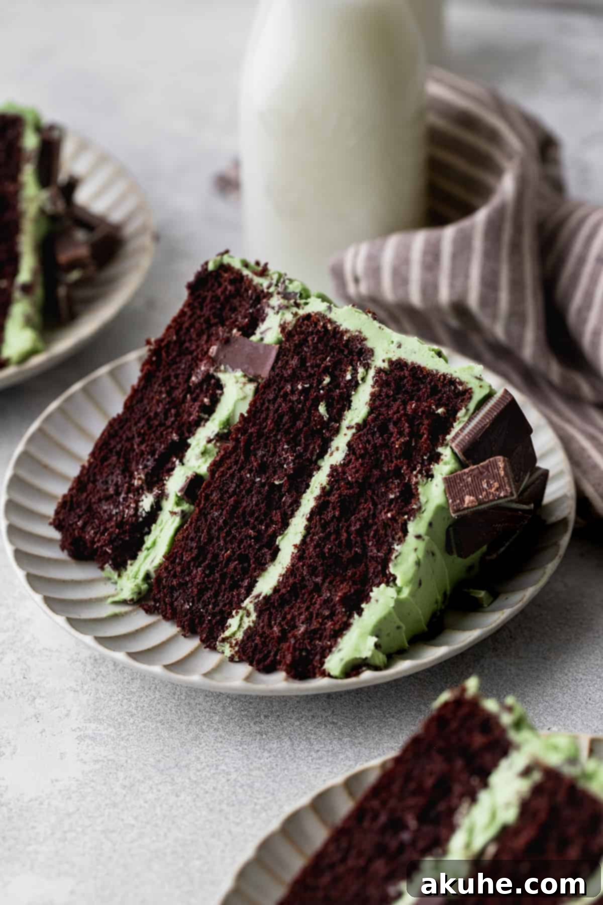 Andes Mint Chocolate Cake 13 Slice of cake on a plate with a glass of milk.