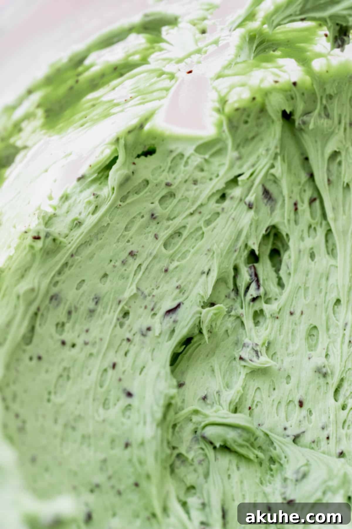Andes Mint Chocolate Cake 8 Chocolate chip mint frosting close up in a glass bowl.