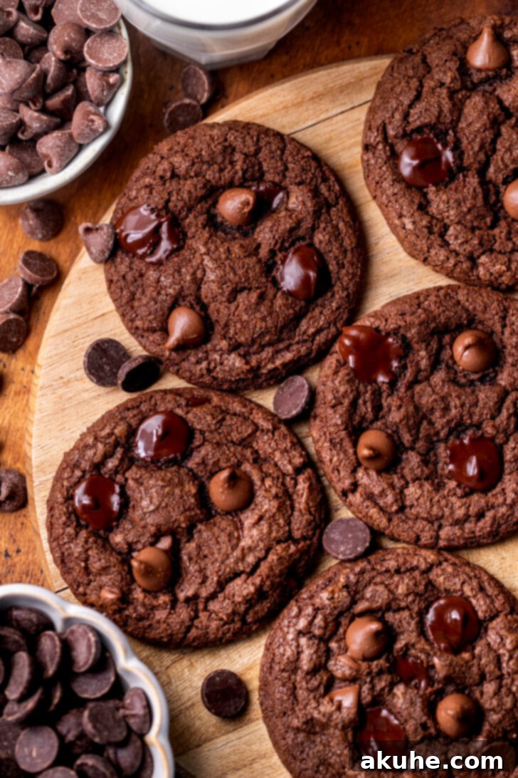 Triple Chocolate Chunk Cookies 2 Triple Chocolate Cookies on a wood platter