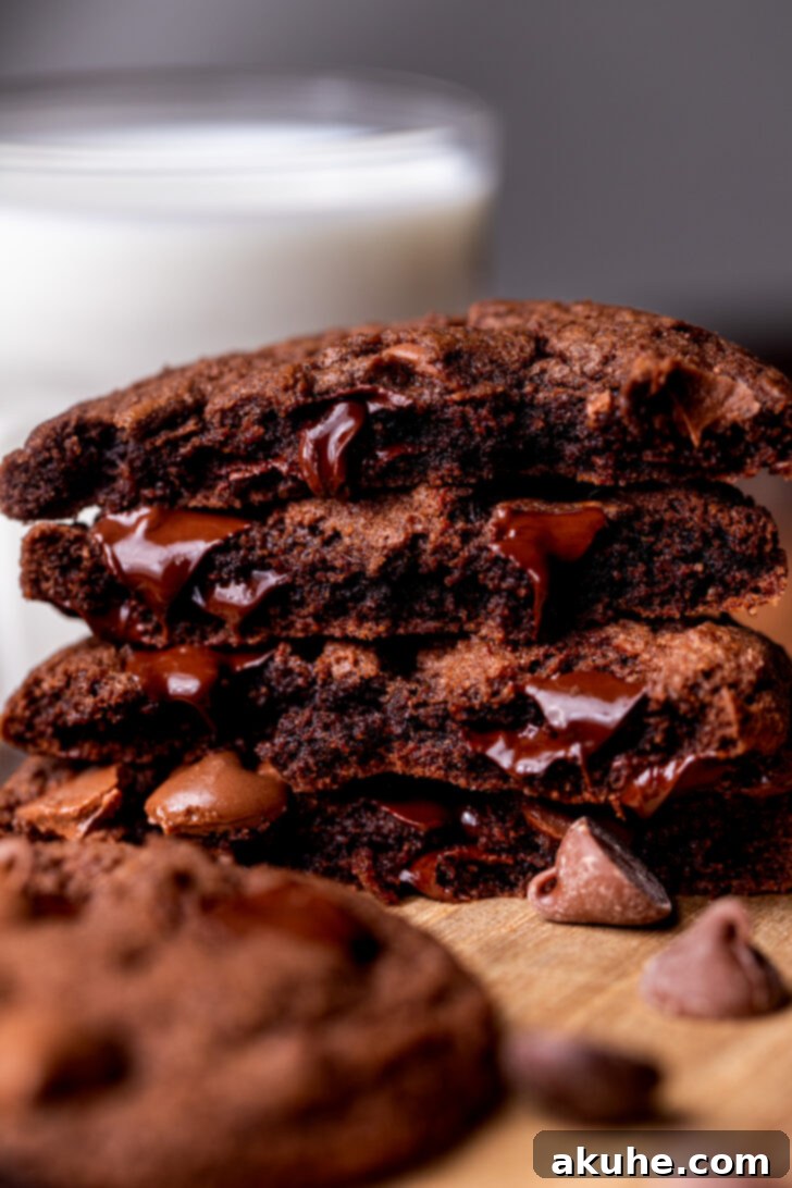 Triple Chocolate Chunk Cookies 3 Triple Chocolate Cookies split in half showing the chocolate inside