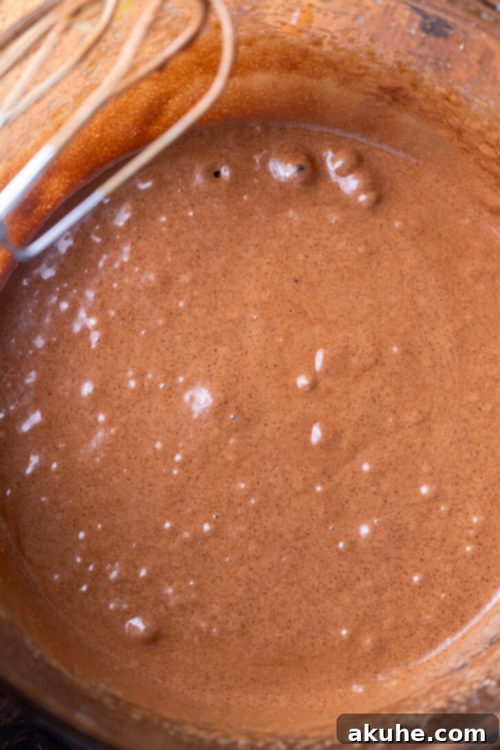 Triple Chocolate Chunk Cookies 4 Wet ingredients being mixed in a bowl