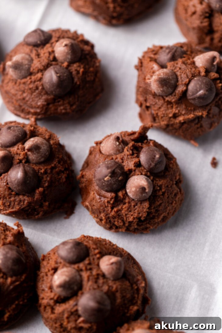 Triple Chocolate Chunk Cookies 6 Cookie dough balls on a cookie sheet