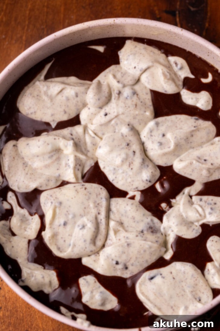 Oreo Dream Cheesecake 6 Oreo cheesecake batter and chocolate cake batter layered in the springform pan.