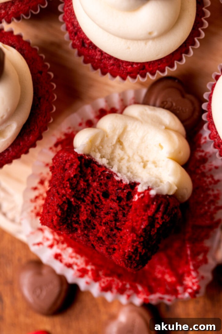 Red Velvet Delight 8 A red velvet cupcake with a bite missing, revealing its soft and vibrant interior.
