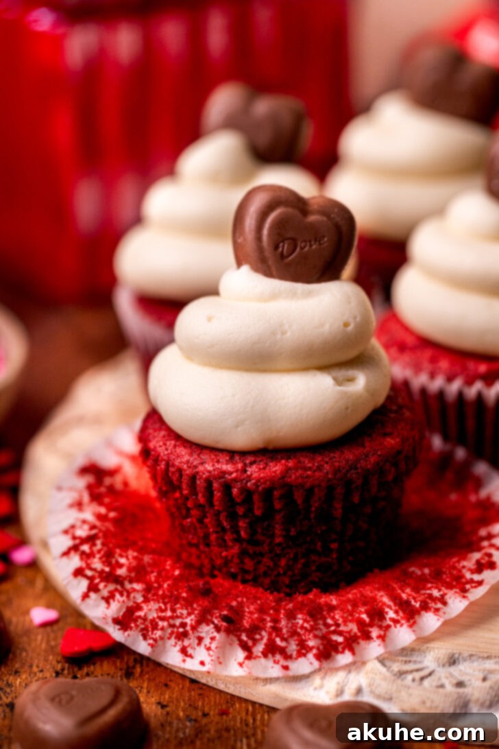 Red Velvet Delight 9 A beautifully decorated red velvet cupcake with its wrapper pulled down.