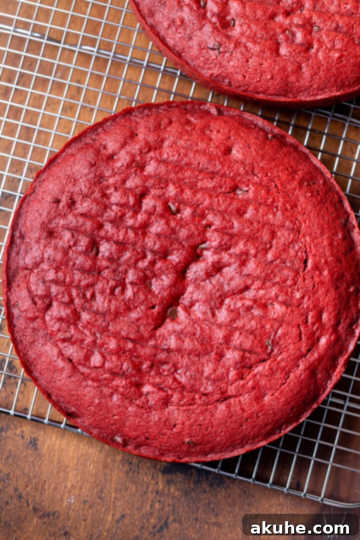 Red velvet cakes cooling on a wire rack after baking.