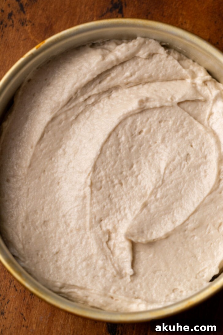 The Ultimate Vanilla Cake Experience 4 Cake batter evenly distributed in a cake pan, ready for baking.